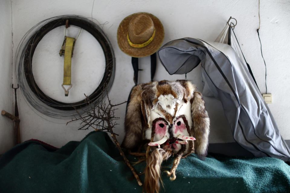 In this photo taken on Monday, Jan. 20, 2020, a mask of "Las Carantonas" is displayed prior of a festival in Acehuche, Spain. The Carantonas involves men pulling on animal hides that make them look like Chewbacca. At the Carantoñas festival in Acehuche, men are helped to pull on hairy, bulky costumes and scary masks before they walk down streets of whitewashed houses looking like wild beasts ("carantoñas"). Women parade in colorful embroidered shawls and skirts as music plays. (AP Photo/Manu Fernandez)