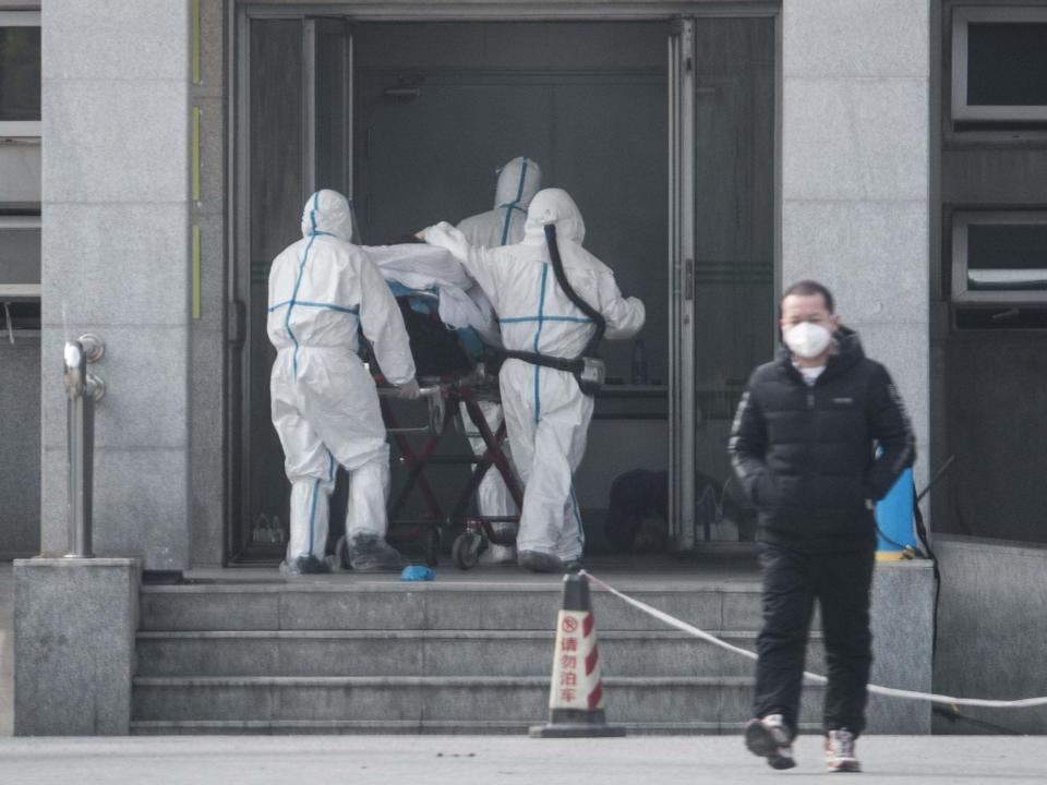 Medical staff carry a patient into Jinyintan hospital, where patients infected with a new strain of coronavirus identified as the cause of the Wuhan pneumonia outbreak are being treated, in Wuhan, China, 18 January 2020: EPA