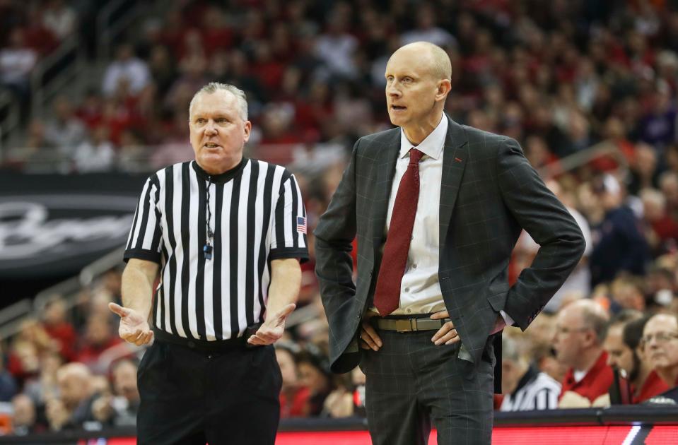 Referee Jamie Luckie tries to explain a call to Louisville coach Chris Mack during the Cards loss to Virginia Feb. 23, 2019.