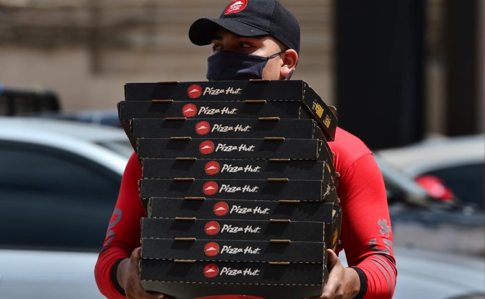 A man delivers pizza in Tegucigalpa, Honduras on July 28, 2020. 