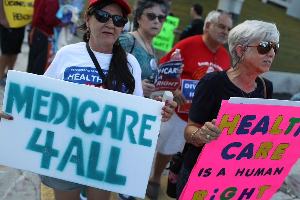 <p>P.J. Espinal (L) and Ronne Denbo join with other protesters against Republican senators who have not spoken up against Affordable Care Act repeal and demand universal, affordable, quality healthcare for all on July 24, 2017 in Fort Lauderdale, Fla. (Photo: Joe Raedle/Getty Images) </p>