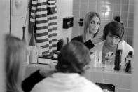 <p>Actress Sharon Tate trims a few inches off of the back of her husband's, director Roman Polanski, hair in the master bathroom of their London apartment. </p>