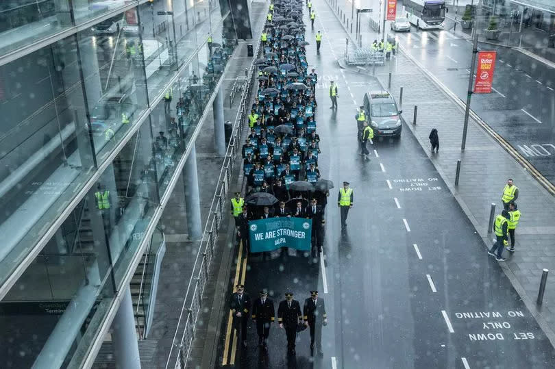 Aer Lingus pilots march around Dublin Airport as they begin their eight-hour strike on Saturday