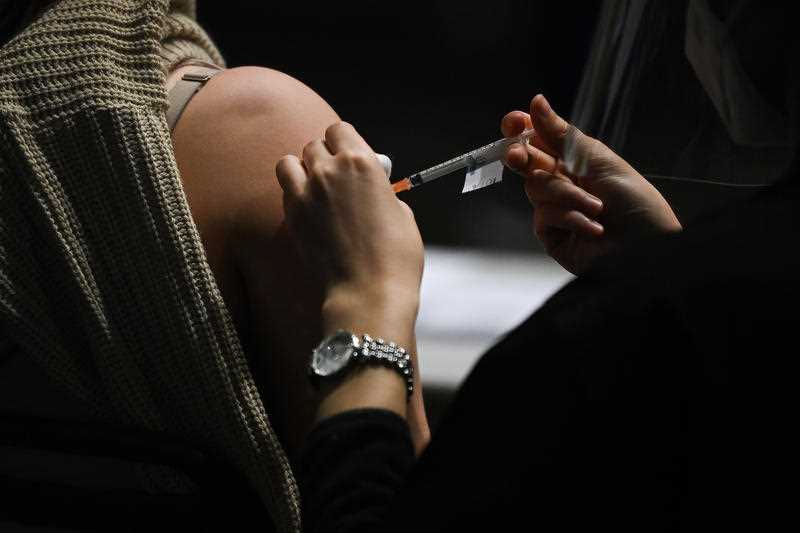 A person is given a Covid-19 vaccination at the NSW Health Walk-in AstraZeneca vaccination clinic at the Bankstown Sports Club in Sydney.