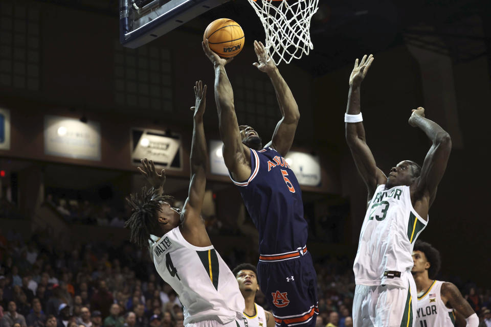 Auburn forward Chris Moore (5) goes up for a layup during an NCAA college basketball game against Baylor, Tuesday, Nov. 7, 2023, in Sioux Falls, S.D. (AP Photo/Josh Jurgens)