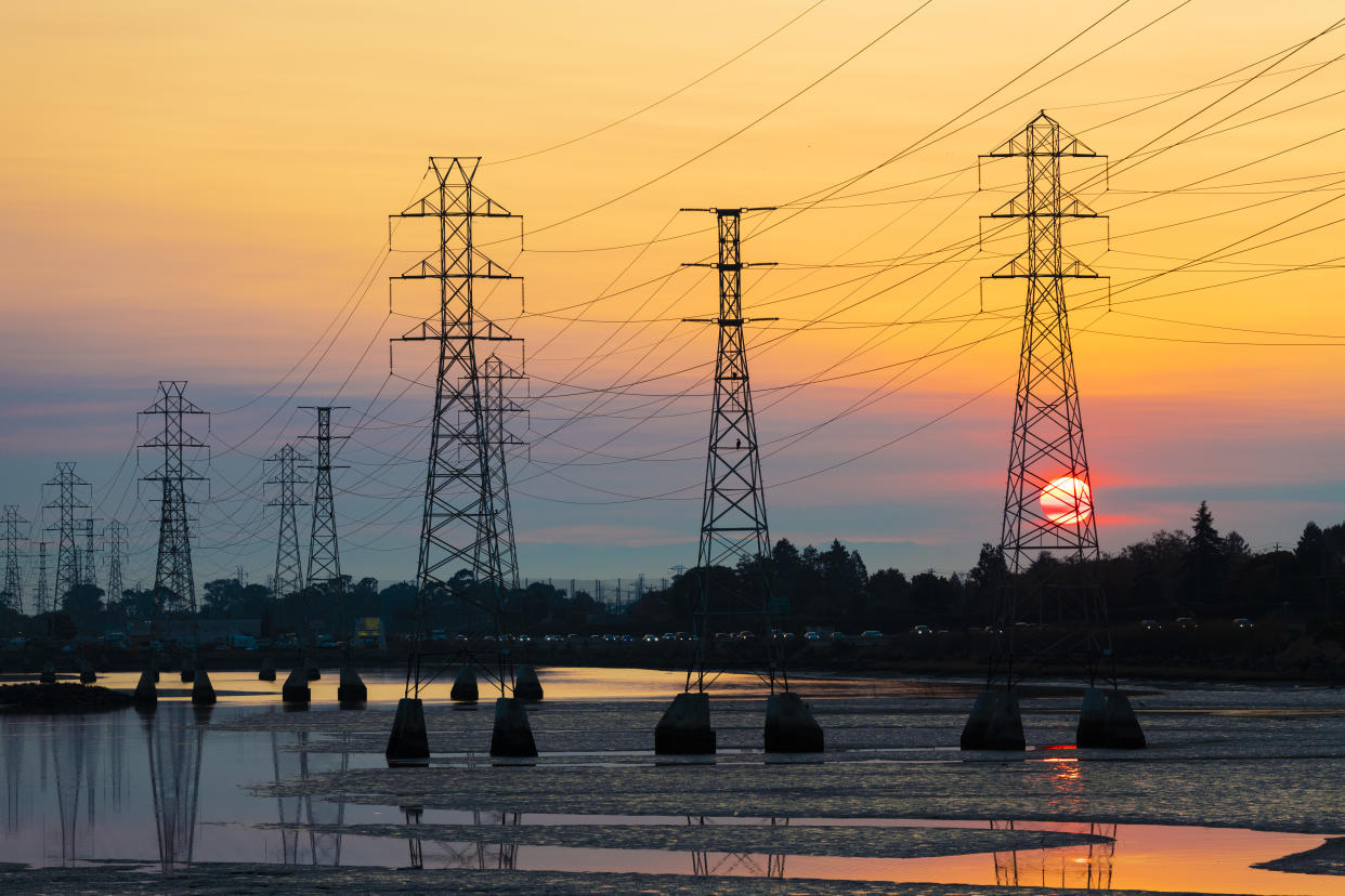 Power transmission tower is silhouetted by the rising sun in Burlingame, California on October 26, 2019. Potentially historic windstorm coming to the San Francisco Bay Area may prompt Pacific Gas and Electric Company, PG&E to shutoff power to as many as 2 million people to lower devastating wildfire risk. (Photo by Yichuan Cao/NurPhoto via Getty Images)