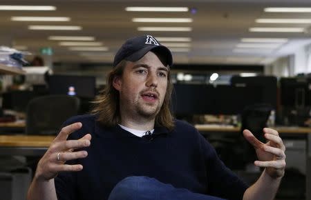 Entrepreneur Mike Cannon-Brookes, co-funder of software firm Atlassian gestures during a Reuters interview in central Sydney June 5, 2013. REUTERS/Daniel Munoz