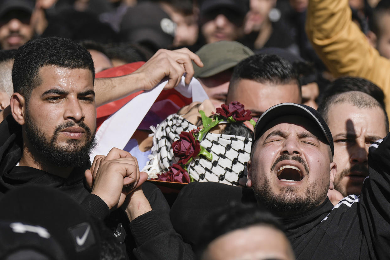 Palestinian mourners carry the body of Yusef Muhaisen during his funeral in the West Bank town of al Ram, north of Jerusalem, Friday, Jan. 27, 2023. Muhaisen, 22, was killed during clashes with Israeli troops. (AP Photo/Majdi Mohammed)