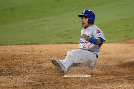 Oct 20, 2016; Los Angeles, CA, USA; Chicago Cubs shortstop Addison Russell (27) slides in safely to score a run in the eighth inning against the Los Angeles Dodgers in game five of the 2016 NLCS playoff baseball series against the Los Angeles Dodgers at Dodger Stadium. Mandatory Credit: Gary A. Vasquez-USA TODAY Sports