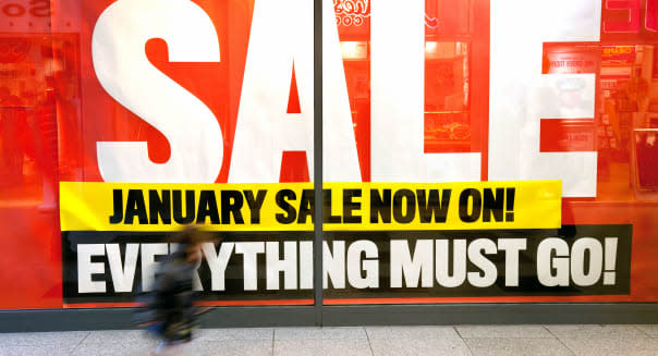 January Sale UK sign shop window and child running, Lion Yard, Cambridge England