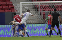 Paraguay's Braian Samudio, second left, scores his side's opening goal against Chile during a Copa America soccer match at the National stadium in Brasilia, Brazil, Thursday, June 24, 2021. (AP Photo/Eraldo Peres)