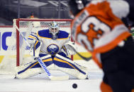 Buffalo Sabres goaltender Carter Hutton watches a shot from Philadelphia Flyers' Oskar Lindblom (23) during the first period of an NHL hockey game Tuesday, Jan. 19, 2021, in Philadelphia. (AP Photo/Derik Hamilton)