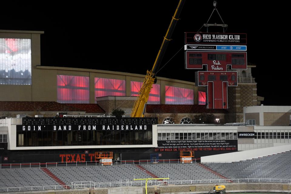 Construction crews remove the Double T scoreboard, Thursday, Dec. 1, 2022, at Jones AT&T Stadium. 