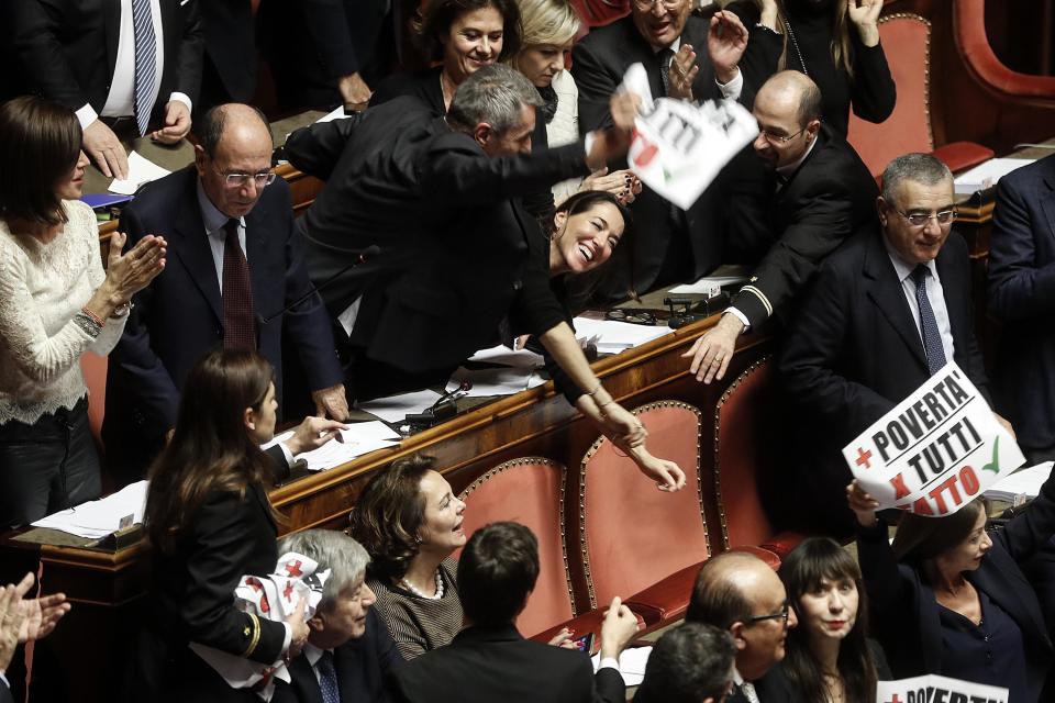 The protest of "Forza Italia" party's senators during the discussion before the vote of confidence on the budget law in the Senate of the Republic, Rome, Italy, Saturday, Dec. 22, 2018. (Riccardo Antimiani/ANSA via AP)