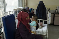 Lina holds her baby boy, Osman, as he undergoes treatment at the malnutrition ward of the Ataturk National Children's Hospital in Kabul, Afghanistan, Thursday, Dec, 2, 2021. According to U.N. figures from early November, almost 24 million people in Afghanistan, around 60% percent of the population, suffer from acute hunger, including 8.7 million living in near famine. (AP Photo/Petros Giannakouris)