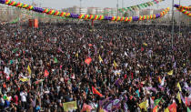 People gesture during a gathering celebrating Newroz, which marks the arrival of spring and the new year, in Diyarbakir, Turkey March 21, 2018. REUTERS/Umit Bektas