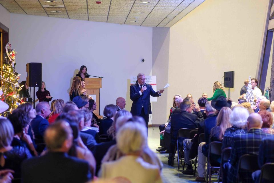 The crowd looks on as the auctioneer pushes up the bids Thursday night at the 2nd annual Tidings of the Trees fundraiser event at the Panhandle-Plains Historical Museum in Canyon.