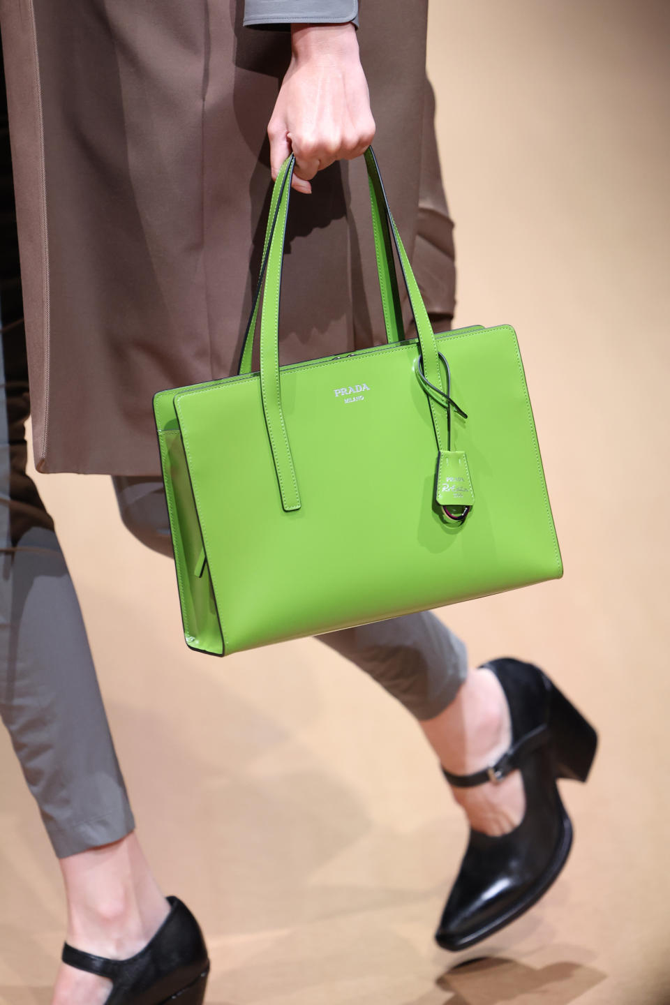 Black Mary Janes and an apple green bag at Prada spring summer ’23 women’s collection. - Credit: WireImage