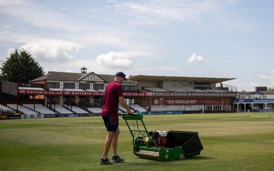 Head groundsman Craig Harvey tends to the outfield at the County Ground, home of Northamptonshire County Cricket Club - PA