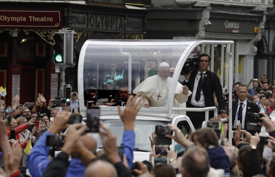 Pope Francis salutes the crawd as he leaves after visiting St Mary's Pro-Cathedral, in Dublin, Ireland, Saturday, Aug. 25, 2018. Pope Francis is on a two-day visit to Ireland. (AP Photo/Matt Dunham)