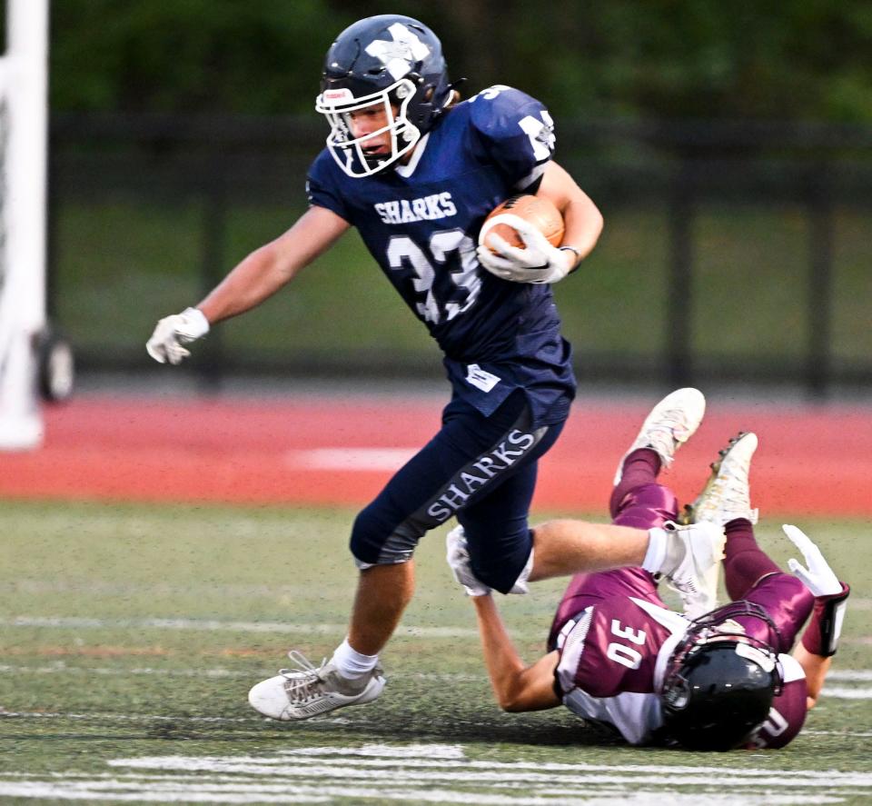 Tyrese Callahan of Cape Tech trips up Dillon Chapman of Monomoy.