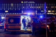 Medical personnel stand next to ambulances with COVID-19 patients as they wait in the queue at Santa Maria hospital, amid the coronavirus disease (COVID-19) pandemic in Lisbon