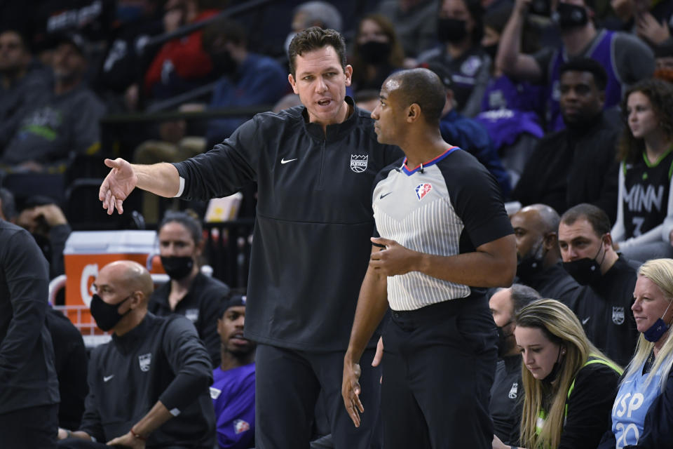 Sacramento Kings head coach Luke Walton, left, talks with referee John Butler during the first half of the team's NBA basketball game against the Minnesota Timberwolves on Wednesday, Nov. 17, 2021, in Minneapolis. The Timberwolves won 107-97. (AP Photo/Craig Lassig)