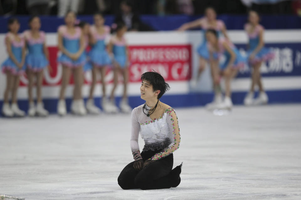 Yuzuru Hanyu of Japan sits on the ice after his performance during the men's free skating in the World Figure Skating Championships in Saitama, near Tokyo, Friday, March 28, 2014. Hanyu barely topped the free skate to become the first man in 12 years on Friday to win the Olympic and world figure skating titles in the same year. (AP Photo/Koji Sasahara)