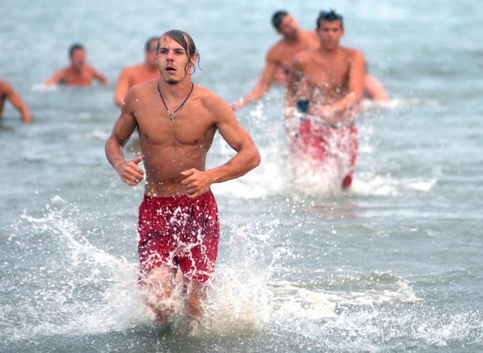 Bluffton’s Steve Peterson runs toward the beach during the first event of the 13th annual Hilton Head Island Beach Patrol Lifeguard Competition on Thursday evening at Coligny Beach. Lifeguards competed in a run-swim-run event, a 100-meter dash and a 400-meter relay.