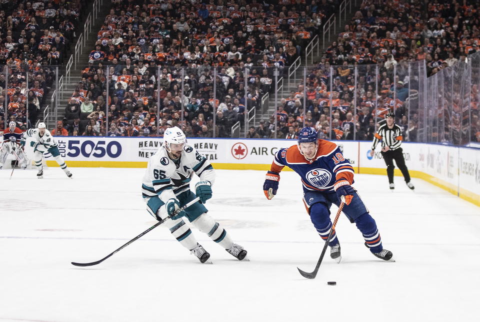 San Jose Sharks' Erik Karlsson (65) pursues Edmonton Oilers' Zach Hyman (18) during second-period NHL hockey game action in Edmonton, Alberta, Monday, March 20, 2023. (Jason Franson/The Canadian Press via AP)