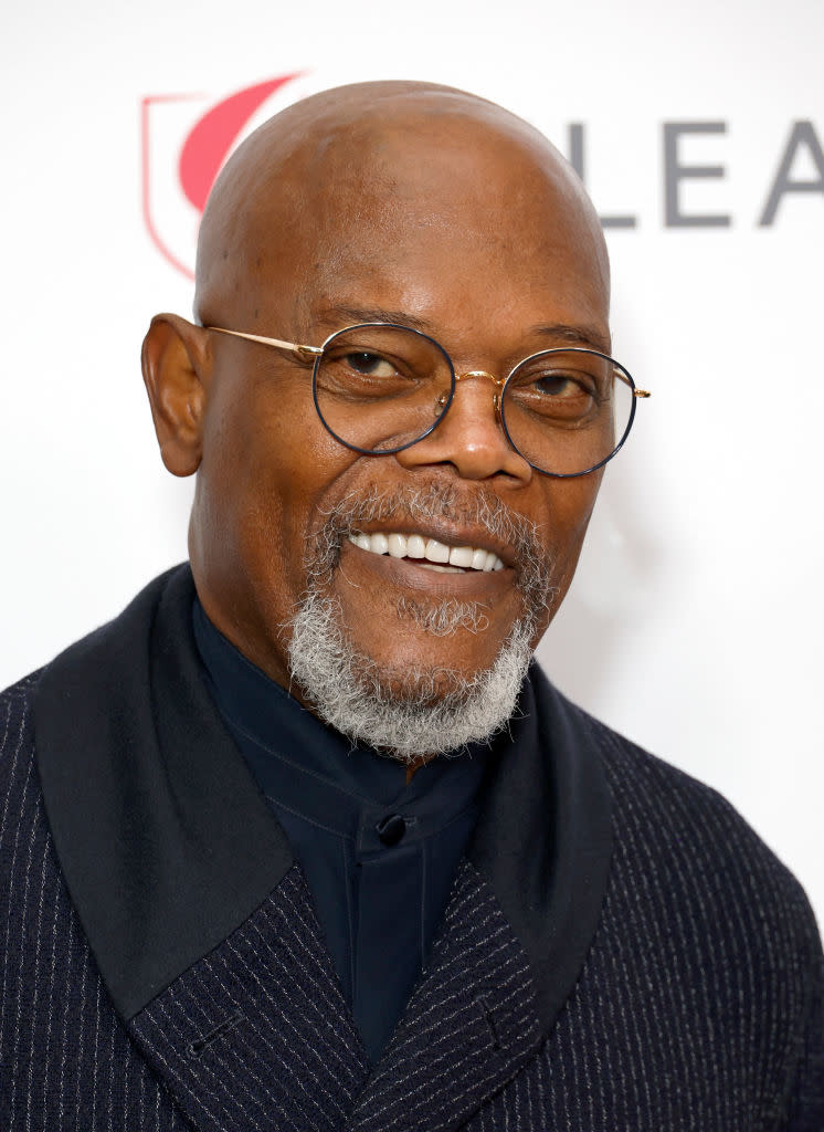 Samuel L. Jackson wearing glasses and a stylish dark jacket at an event