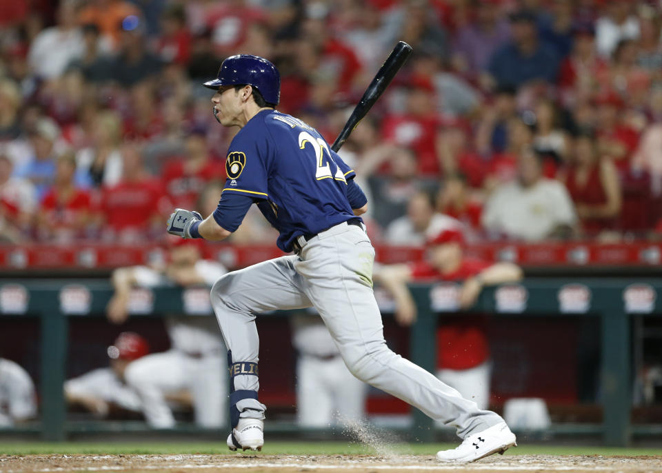 Milwaukee Brewers' Christian Yelich (22) follows through on an RBI single off Cincinnati Reds relief pitcher David Hernandez during the seventh inning of a baseball game, Monday, July 1, 2019, in Cincinnati. (AP Photo/Gary Landers)