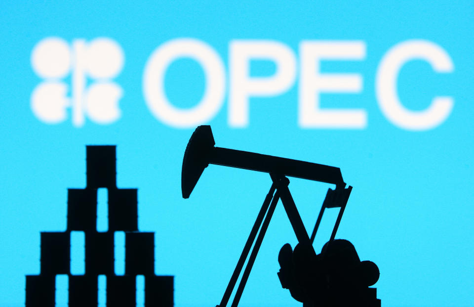 OPEC (Organization of the Petroleum Exporting Countries) organization logo and miniature models of an oil derrick pump and oil barrels are pictured in this illustration photo taken in Kyiv on 14 August, 2021. (Photo by STR/NurPhoto via Getty Images)