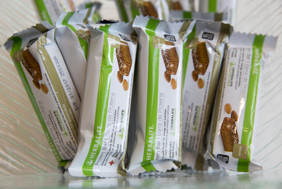 FILE- This May 11, 2016, file photo, shows Herbalife protein bars at Herbalife's corporate office in Los Angeles. Some distributors who claim they were duped by Herbalife’s promises they’d get rich selling health and personal care products are suing the company for as much as $1 billion in damages. (AP Photo/Damian Dovarganes, File)