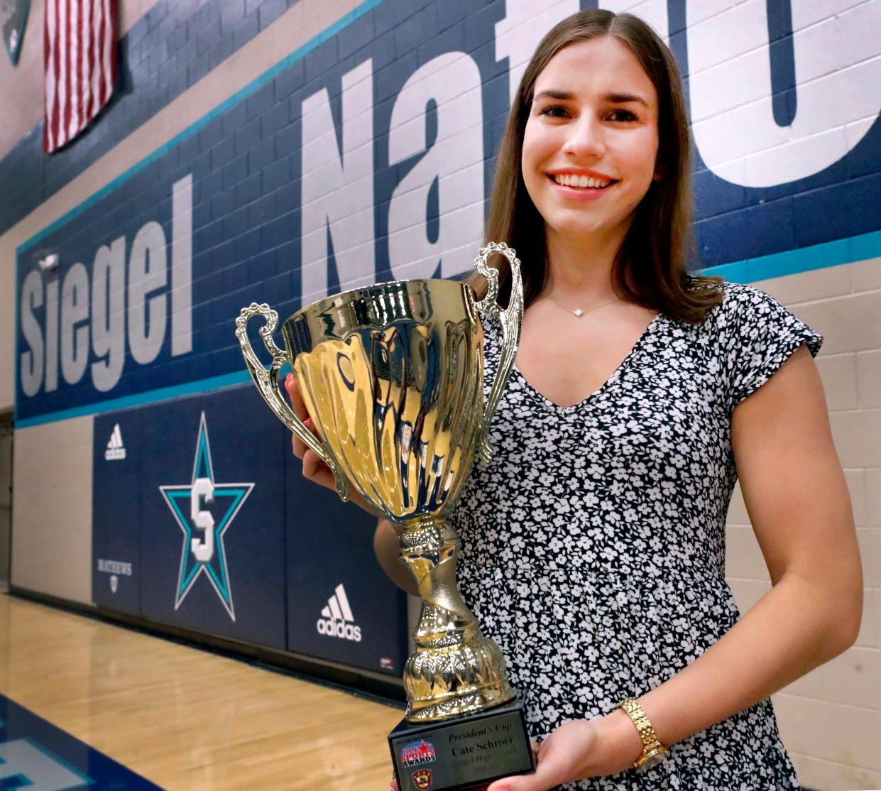 Siegel volleyball player Cate Schroer holds The Daily News Journal’s All Sports Awards President’s Cup for the 2023-2024 school year after receiving the award, on Thursday, June 27, 2024, at Siegel High School.