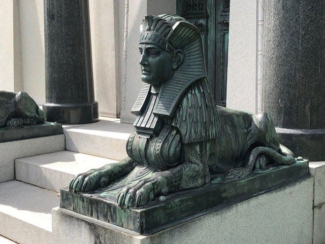 A pair of bronze sphinxes guard the entry to the mausoleum in Pioneer Rest Cemetery, Two Rivers.