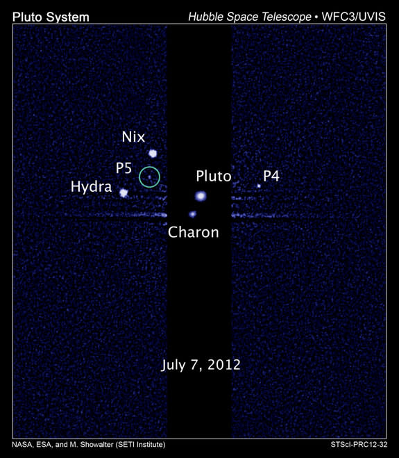 This image, taken by NASA's Hubble Space Telescope, shows five moons orbiting the distant, icy dwarf planet Pluto. The green circle marks the newly discovered moon, designated P5, as photographed by Hubble's Wide Field Camera 3 on July 7, 2012.