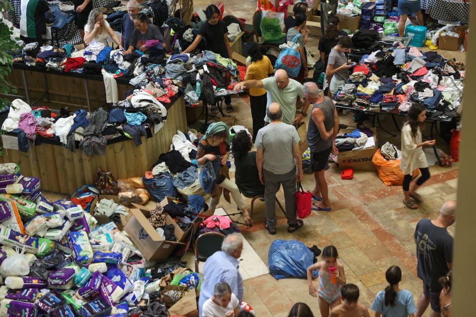 Israeli evacuees from kibbutzim near the Gaza border receive clothing donations at a hotel in the Dead Sea area on Oct. 9, 2023. <a href="https://www.gettyimages.com/detail/news-photo/israeli-evacuees-from-kibbutzim-near-the-gaza-border-news-photo/1715759986?adppopup=true" rel="nofollow noopener" target="_blank" data-ylk="slk:Gil Cohen-Magen/AFP via Getty Images;elm:context_link;itc:0;sec:content-canvas" class="link ">Gil Cohen-Magen/AFP via Getty Images</a>