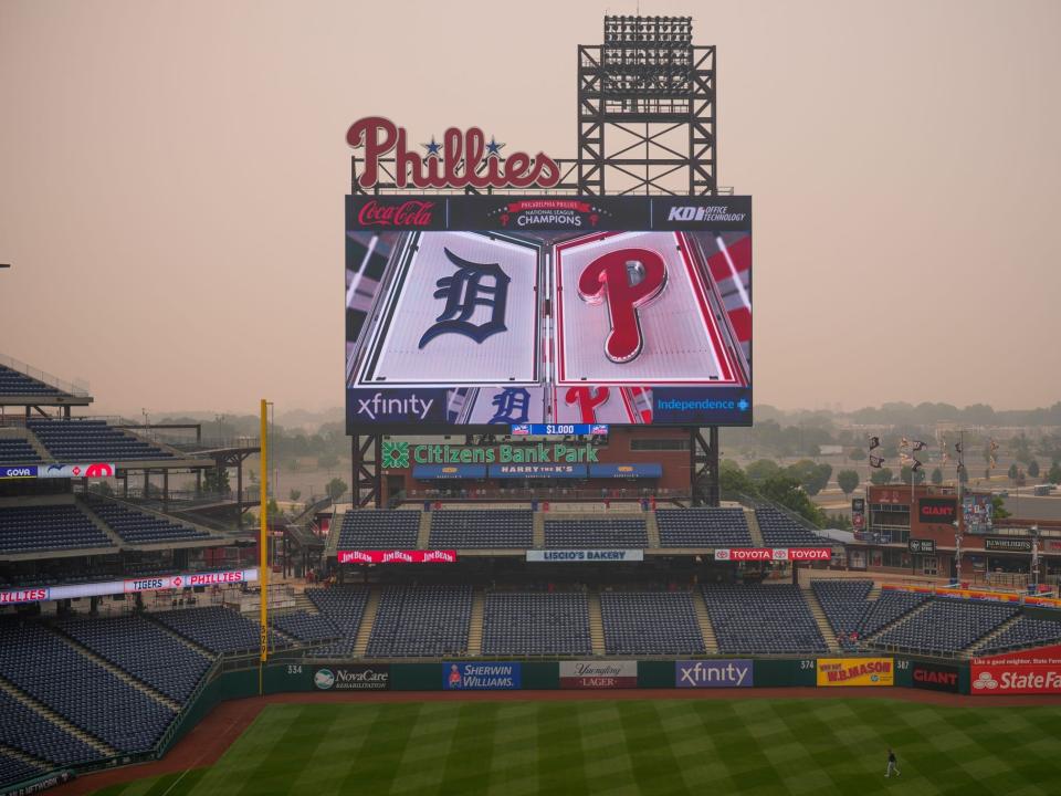 A Detroit Tigers' player walks through the outfield at Citizens Bank Park after poor air quality postponed a baseball game between the Philadelphia Phillies and the Detroit Tigers, Wednesday, June 7, 2023, in Philadelphia.