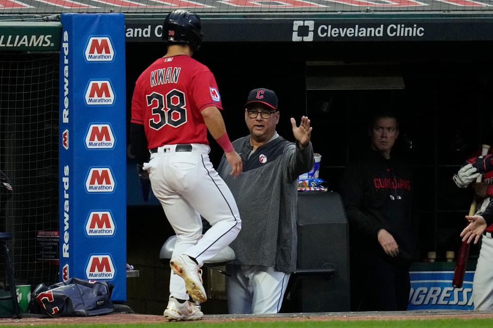 Guardians manager Terry Francona, center, greets Steven Kwan, who returns to the dugout after scoring against the Cincinnati Reds in the third inning, Wednesday, Sept. 27, 2023, in Cleveland.