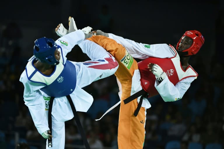 Ivory Coast's Cheick Sallah Cisse (R) created history for the West African country when he stunned Britain's Lutalo Muhammad with a four-point score for Olympic gold right at the end in the men's -80kg taekwondo