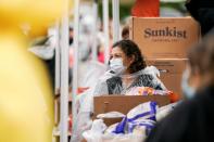 A volunteer with Los Angeles County Federation of Labor, AFL-CIO, hands out boxes of food to LAX workers in the parking lot of The Forum during the outbreak of the coronavirus disease (COVID-19), in Inglewood