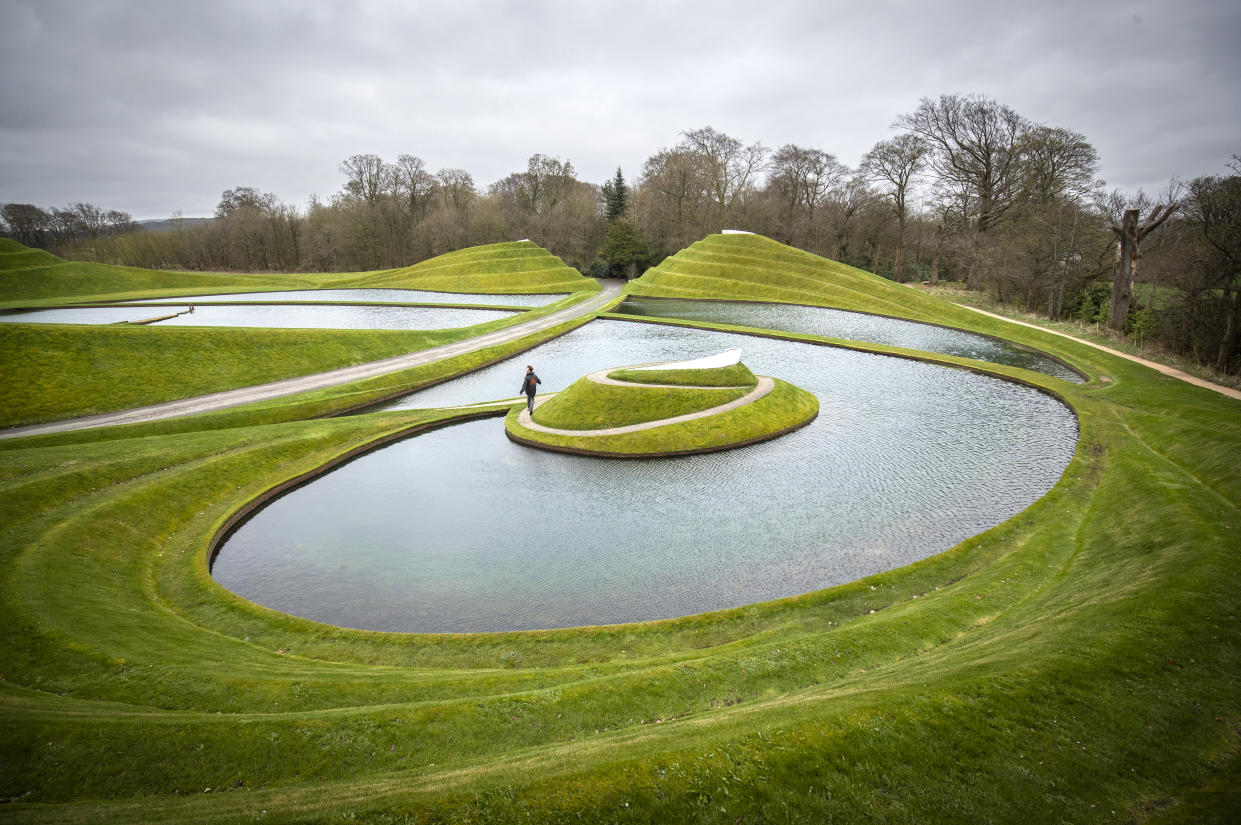 Grassy hills and water formed as an artwork