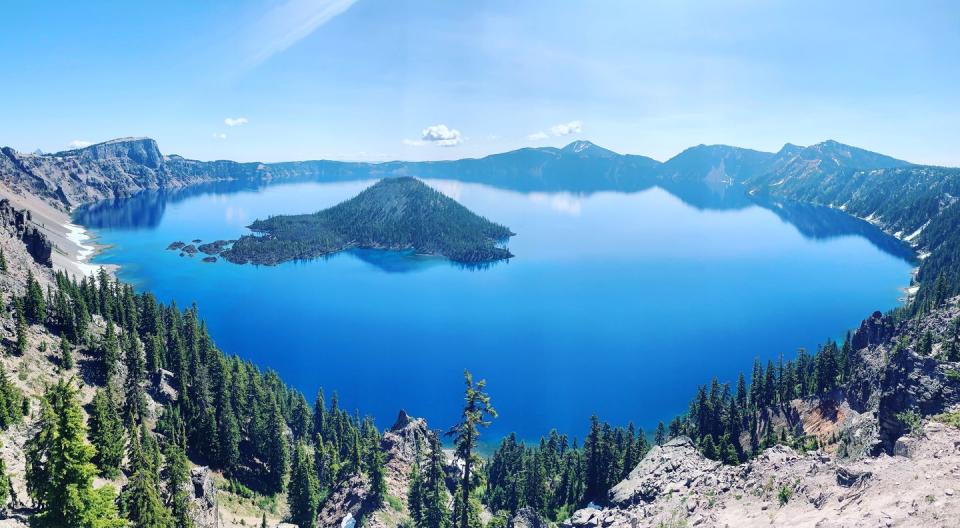 <p>Panoramic view of Crater Lake (which is literally a lake in a volcanic crater) atop the Cascade Mountain Range in Oregon, USA.</p>