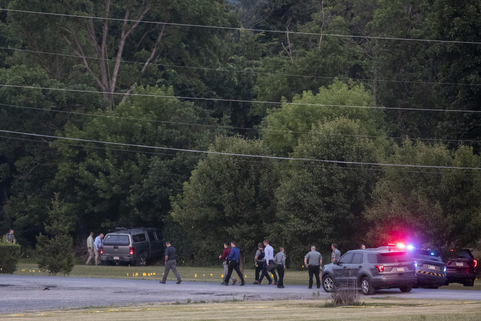 Law enforcement work the scene after a shooting near Mifflintown, Pa., Saturday, June 17, 2023. A state trooper and a suspect were both killed Saturday in a shootout in central Pennsylvania, hours after the suspect seriously wounded another trooper, state police said. (Sean Simmers/The Patriot-News via AP)