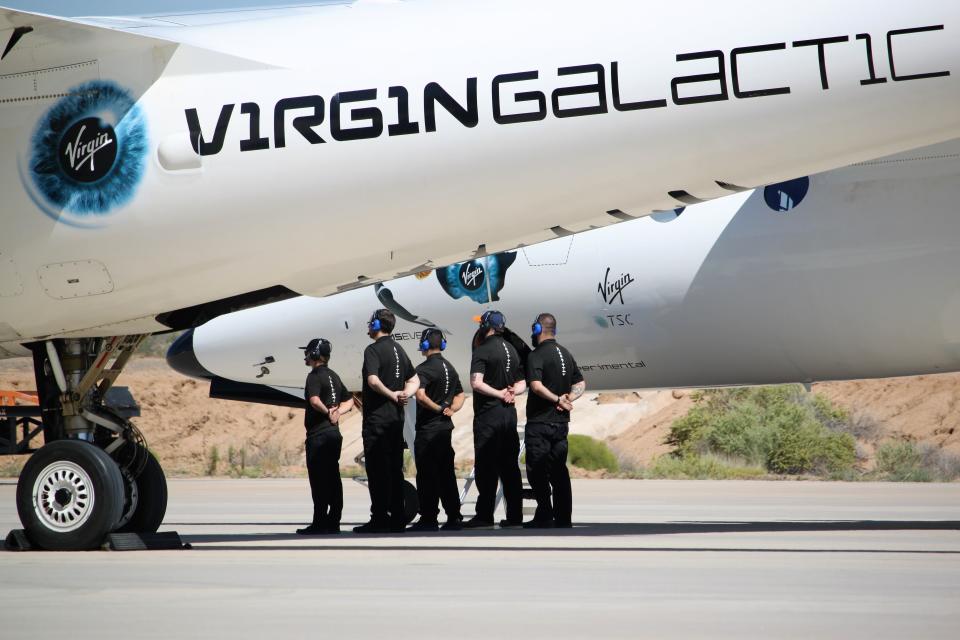 Virgin Galactic ground crew waits for the pilots of the WhiteKnightTwo carrier aircraft to disembark after landing at Spaceport America on Thursday, August 15, 2019.