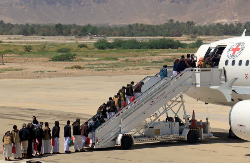 Houthi prisoners board a plane before heading to Sanaa airport after being released by the Saudi-led coalition in a prisoner swap, at Sayoun airport