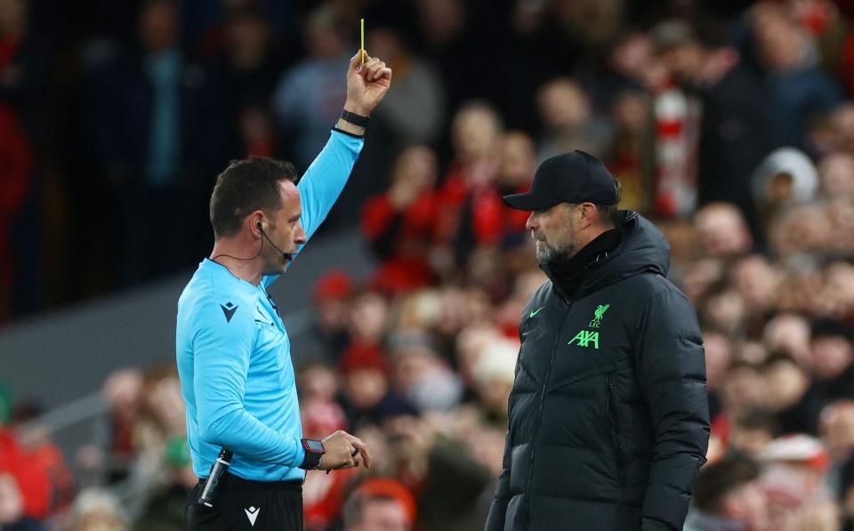 Jurgen Klopp is booked by referee Artur Dias