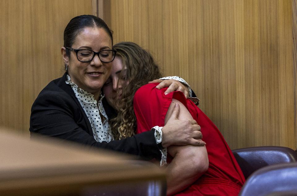 Defense attorney Tara Kawass and OnlyFans model Courtney Clenney react during a hearing in front of Judge Laura Shearon Cruz, where the computer hacking charges against her and her parents, Deborah and Kim Clenney, were dismissed at the Gerstein Justice Building, Thursday, July 11, 2024, in Miami. Courtney Clenney is accused of stabbing to death her boyfriend in a Miami condo in 2022. The murder charge has not been dropped. (Pedro Portal/Miami Herald via AP)