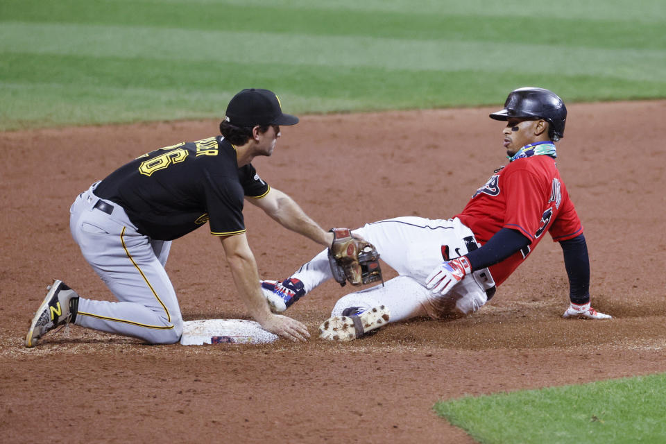 Pittsburgh Pirates' Adam Frazier (26) tags out Cleveland Indians' Francisco Lindor attempting to stretch a single into a double during the third inning of a baseball game Saturday, Sept. 26, 2020, in Cleveland. (AP Photo/Ron Schwane)